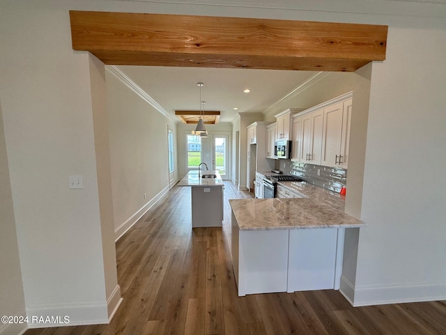 kitchen with dark hardwood / wood-style flooring, sink, decorative backsplash, white cabinets, and kitchen peninsula