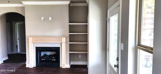 unfurnished living room with crown molding, a healthy amount of sunlight, and dark hardwood / wood-style flooring