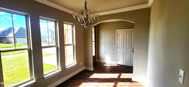 unfurnished dining area featuring ornamental molding, a chandelier, and hardwood / wood-style flooring