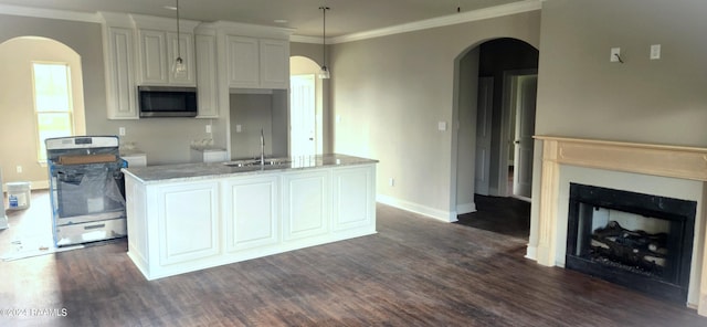 kitchen featuring dark wood-type flooring, sink, stainless steel appliances, and light stone countertops