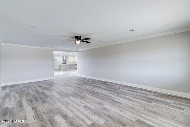 unfurnished room featuring ceiling fan, light hardwood / wood-style flooring, and crown molding