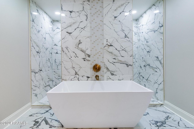 bathroom featuring tile floors and a bathtub