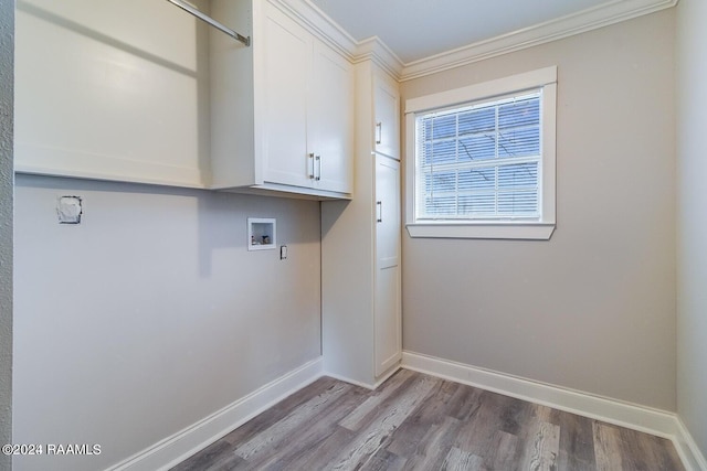 laundry room with washer hookup, ornamental molding, light hardwood / wood-style flooring, and cabinets