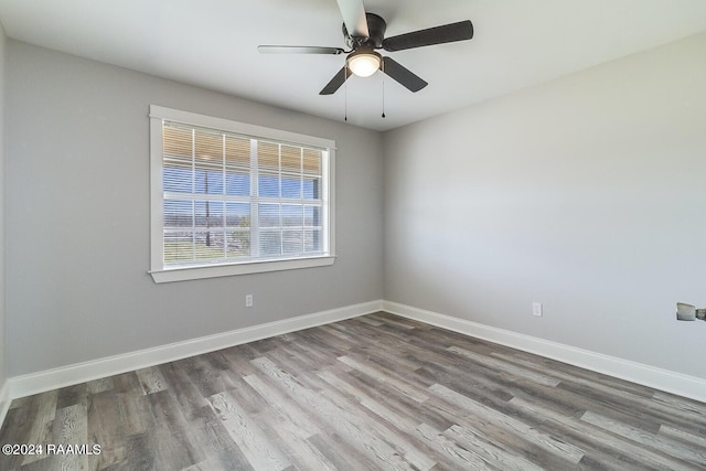 spare room with wood-type flooring and ceiling fan