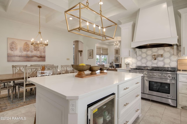 kitchen with a kitchen island, premium range hood, wine cooler, double oven range, and tasteful backsplash