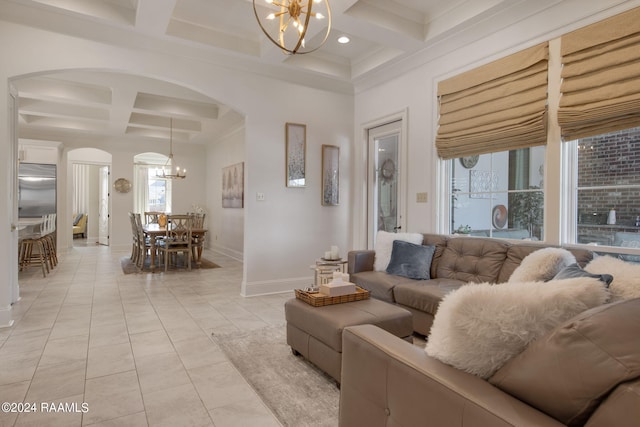 tiled living room with beamed ceiling, coffered ceiling, and a chandelier