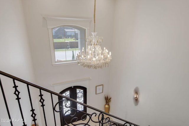 interior space with a chandelier and a towering ceiling