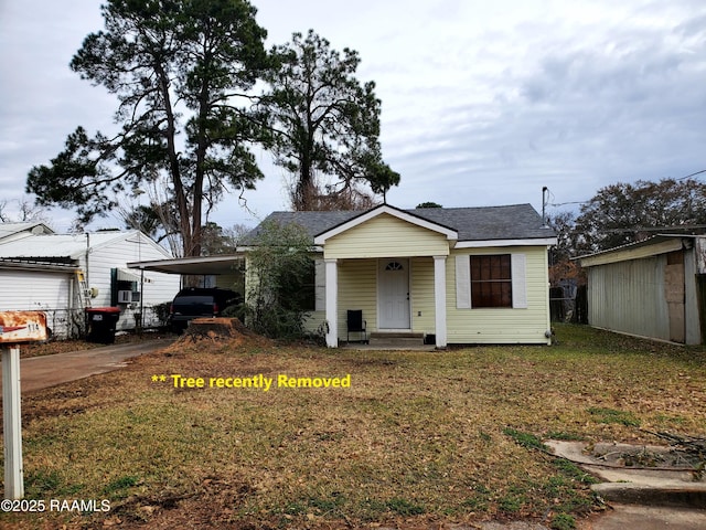 bungalow-style home featuring a carport and a front yard