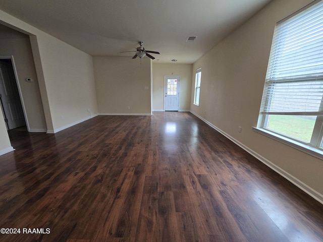 spare room with ceiling fan and dark hardwood / wood-style flooring