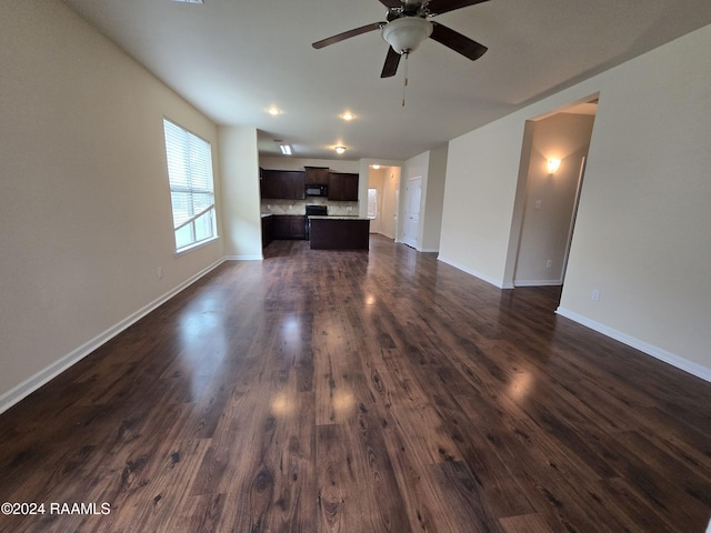 unfurnished living room with dark hardwood / wood-style floors and ceiling fan