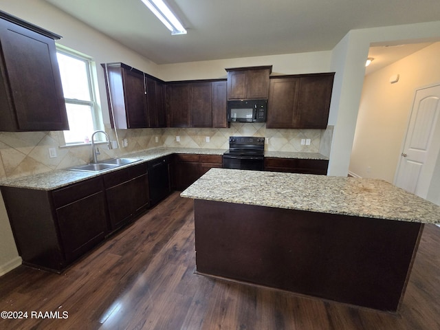 kitchen with dark brown cabinetry, sink, a center island, dark hardwood / wood-style flooring, and black appliances