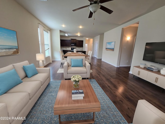 living room with ceiling fan and dark hardwood / wood-style flooring