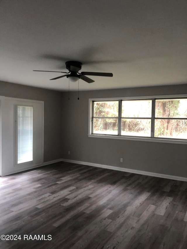 unfurnished room featuring ceiling fan and dark wood-type flooring