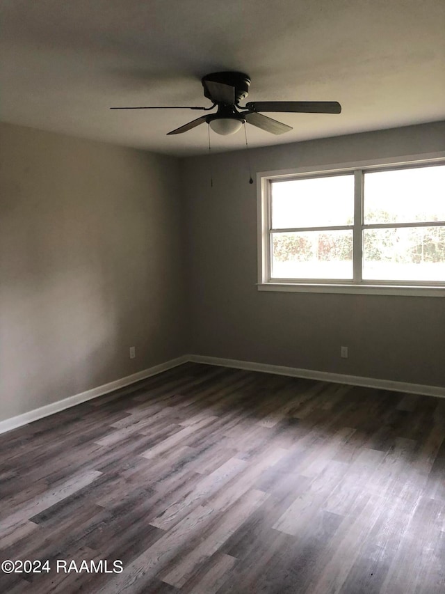 spare room featuring ceiling fan and dark hardwood / wood-style floors