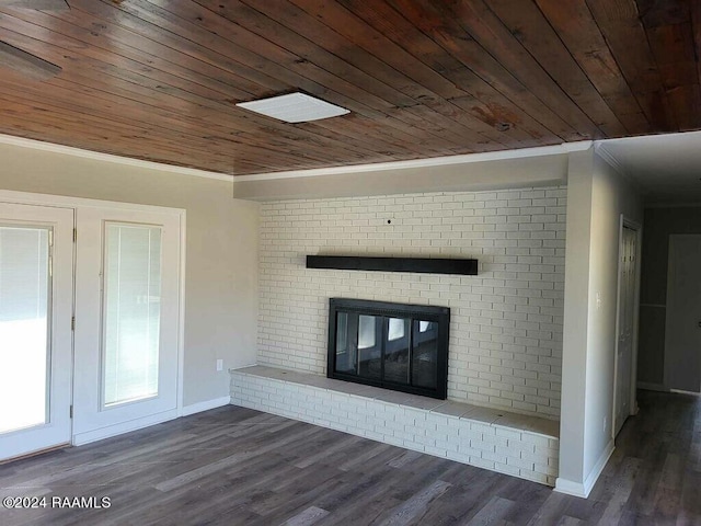 unfurnished living room featuring crown molding, brick wall, wooden ceiling, a fireplace, and dark hardwood / wood-style flooring