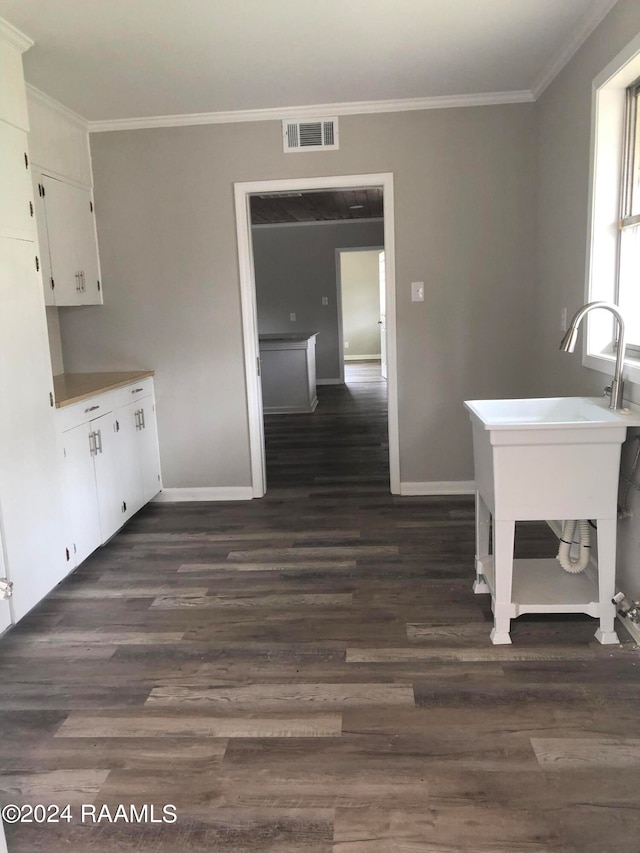 unfurnished dining area featuring ornamental molding and dark hardwood / wood-style floors