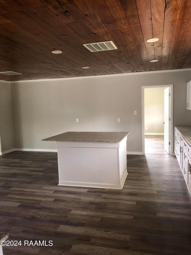 kitchen with wood ceiling, white cabinetry, dark hardwood / wood-style floors, and light stone countertops