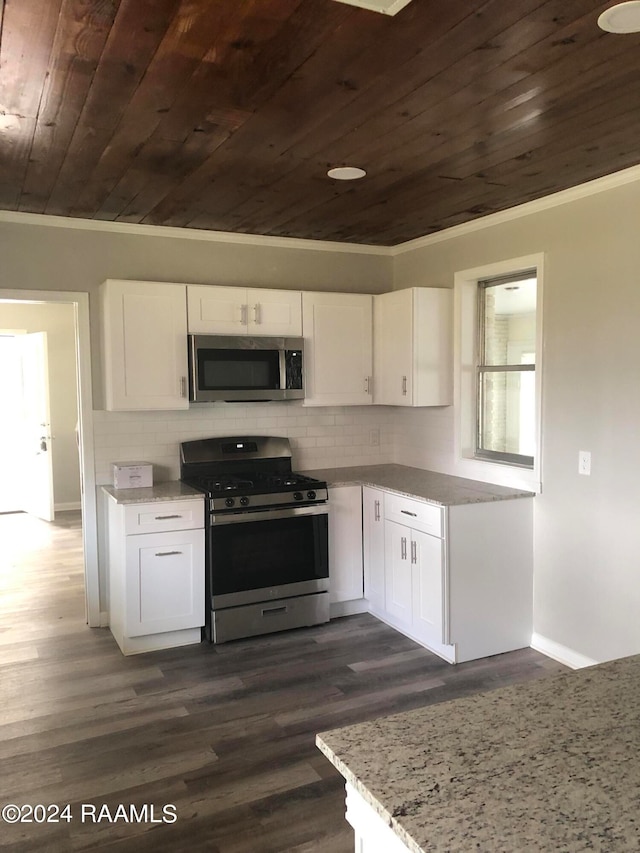 kitchen with tasteful backsplash, dark wood-type flooring, stainless steel appliances, and wooden ceiling