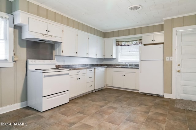 kitchen with white cabinets, dark tile flooring, and white appliances