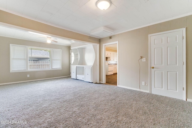 empty room with ceiling fan, light carpet, and ornamental molding