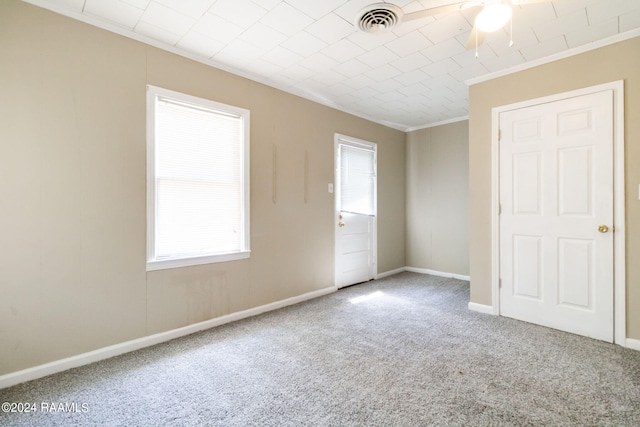 unfurnished bedroom featuring light carpet, multiple windows, and ceiling fan