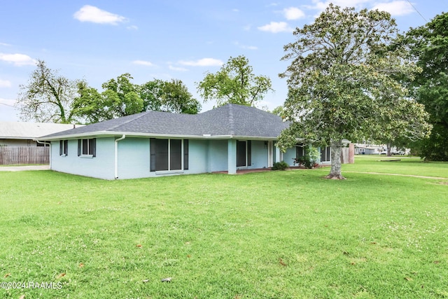 rear view of property featuring a yard