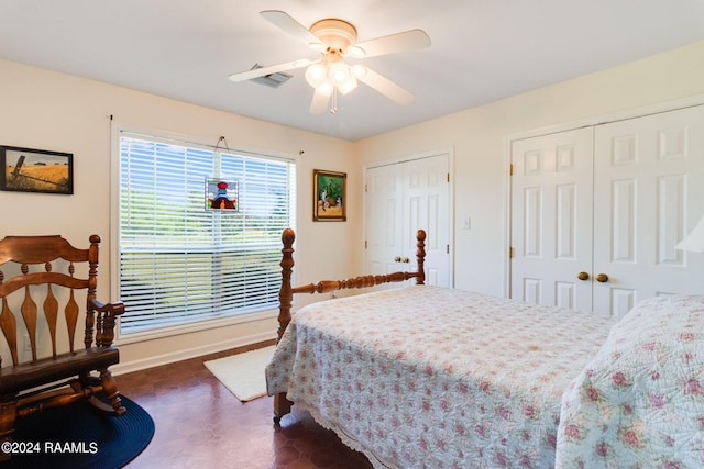 bedroom with multiple closets and ceiling fan