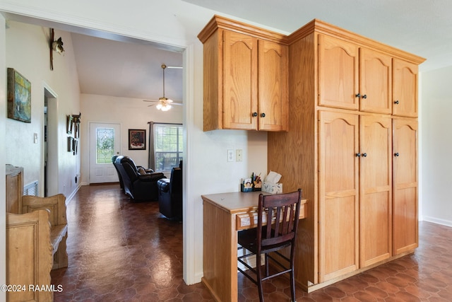 kitchen with light brown cabinetry, vaulted ceiling, and ceiling fan