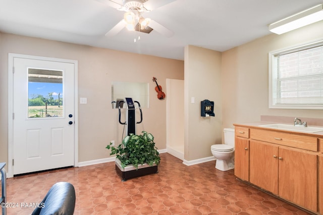 bathroom featuring tile flooring, ceiling fan, vanity, and toilet