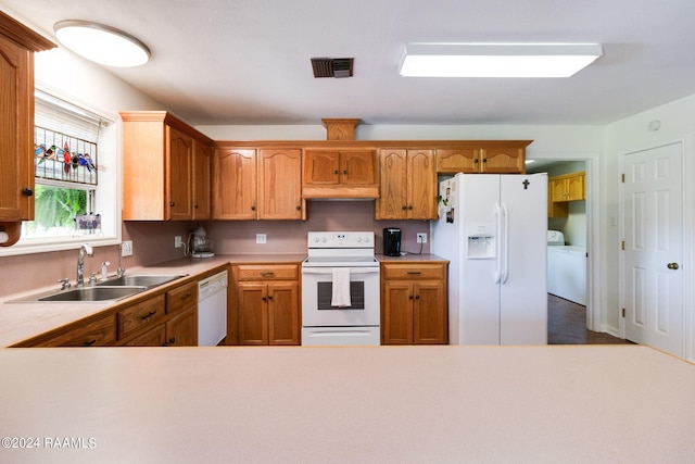 kitchen with sink, white appliances, and hardwood / wood-style flooring