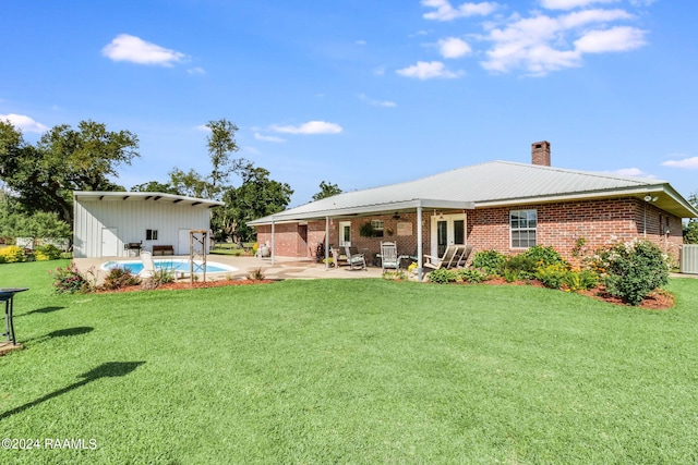 back of house featuring a patio, central AC, and a lawn