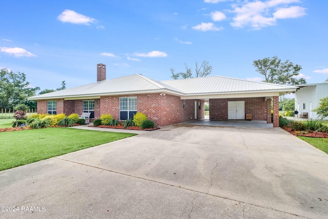 single story home with a carport and a front lawn