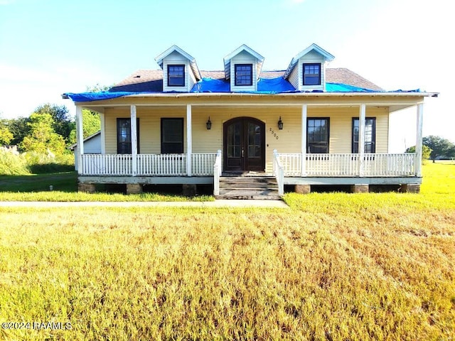 view of front of property with a front yard and a porch