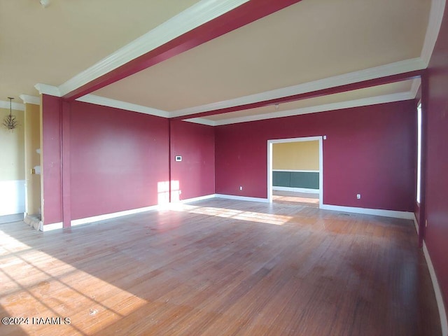 spare room with hardwood / wood-style flooring and crown molding