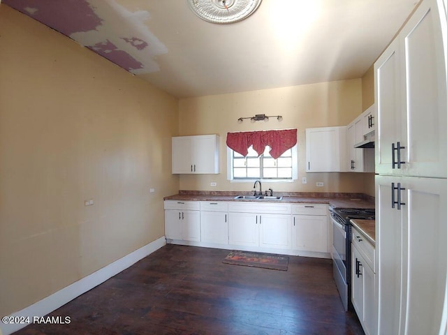 kitchen featuring dark wood-type flooring, white cabinets, stainless steel stove, and sink