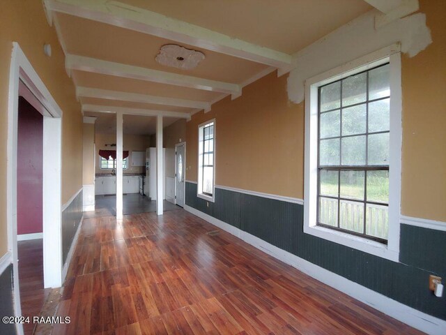 interior space featuring hardwood / wood-style floors and beam ceiling