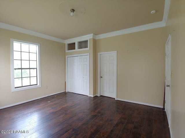 unfurnished bedroom featuring crown molding, hardwood / wood-style floors, and a closet