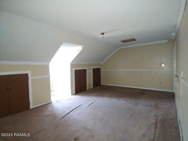 bonus room featuring lofted ceiling and carpet