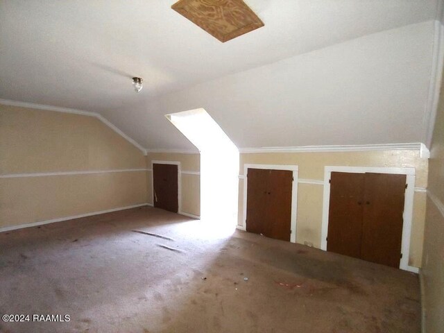 bonus room featuring lofted ceiling and carpet flooring