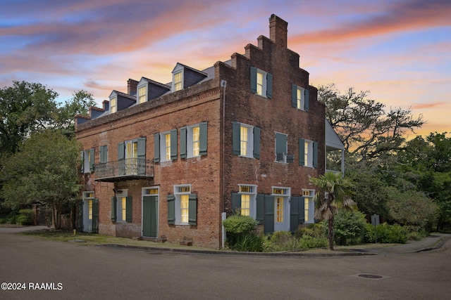 view of outdoor building at dusk