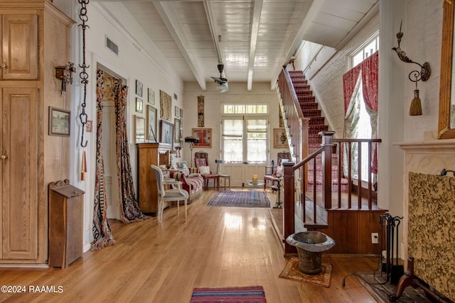 hallway featuring beamed ceiling, light hardwood / wood-style flooring, and wood ceiling