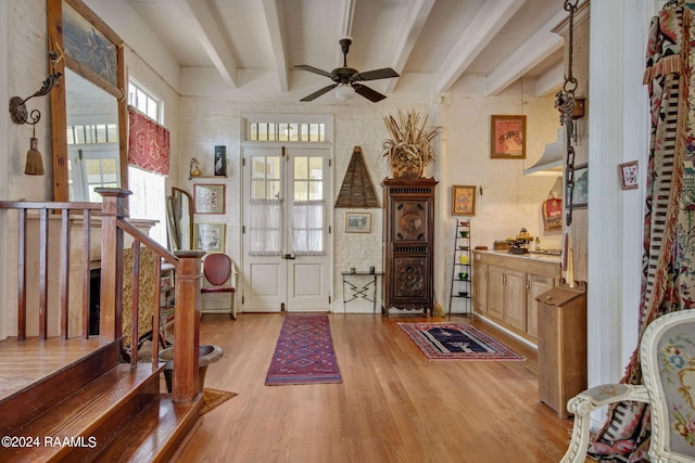 entrance foyer featuring beamed ceiling, light hardwood / wood-style flooring, and ceiling fan