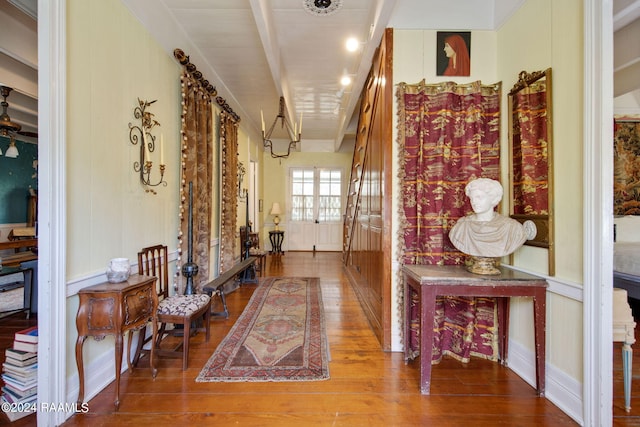 corridor featuring beamed ceiling and hardwood / wood-style floors