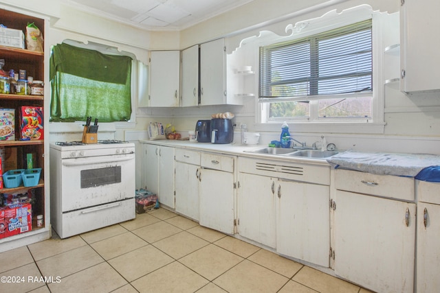 kitchen featuring white cabinets, white gas range, sink, light tile floors, and ornamental molding