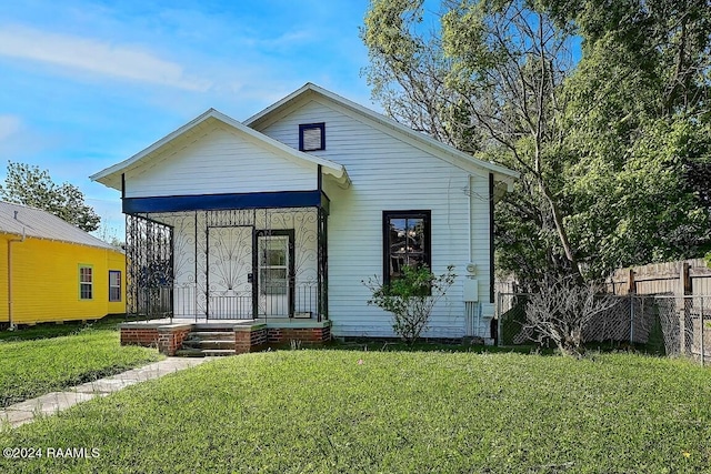 view of front of property with a porch and a front yard