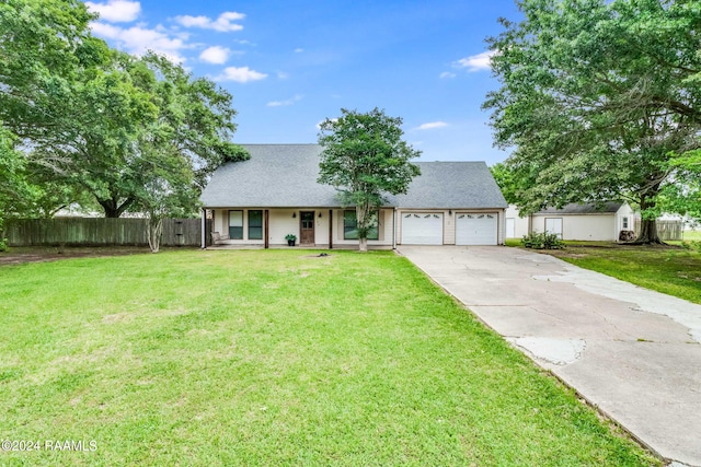 view of front of home with a front yard and a garage