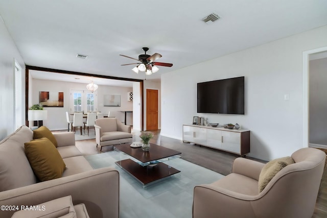 living room featuring ceiling fan and dark hardwood / wood-style flooring