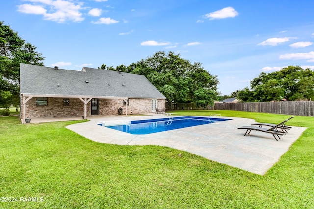 view of pool with a patio and a yard