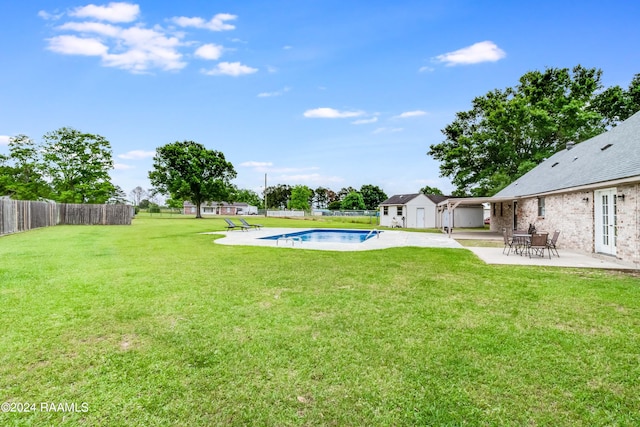 view of yard with a fenced in pool and a patio