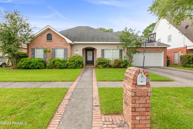 view of front of home featuring a garage and a front lawn